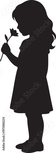 Silhouette of a young girl smelling a flower