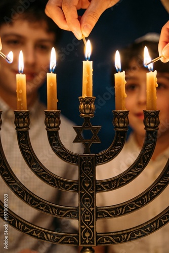 Wallpaper Mural Close-up of hands lighting candles on a traditional Hanukkah menorah with a young boy and girl in the background. Torontodigital.ca