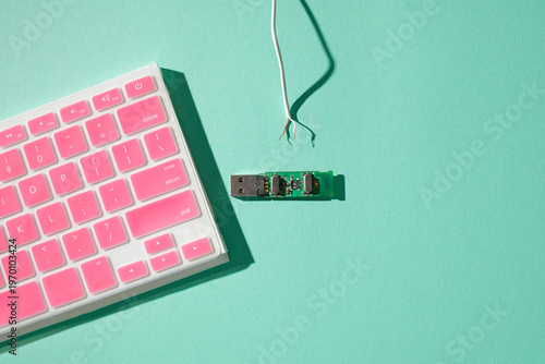 Detail of pink keyboard with exposed wires, USB board, flat lay, copy space