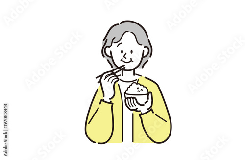 ご飯を食べているシニア女性