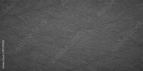 Black asphalt texture background with rough dark surface pattern in black and white tones