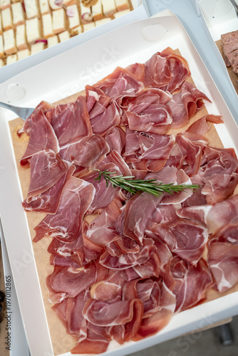 Cured Italian Prosciutto Ham with Rosemary Garnish in Catering Box