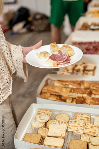 Gourmet Tapas Buffet with prosciutto ham, Meat, Cheese, and Bread in White Catering Boxes