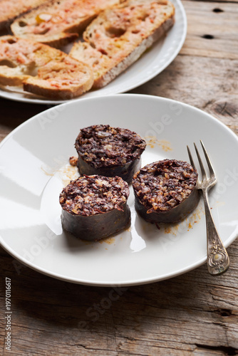 Burgos Blood Sausage Served on a Plate With Bread in a Rustic Setting