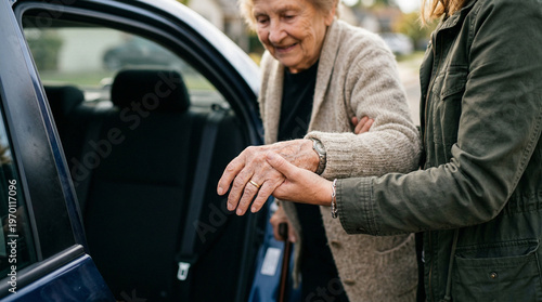 Helping elderly woman into taxi with assistance from caregiver  