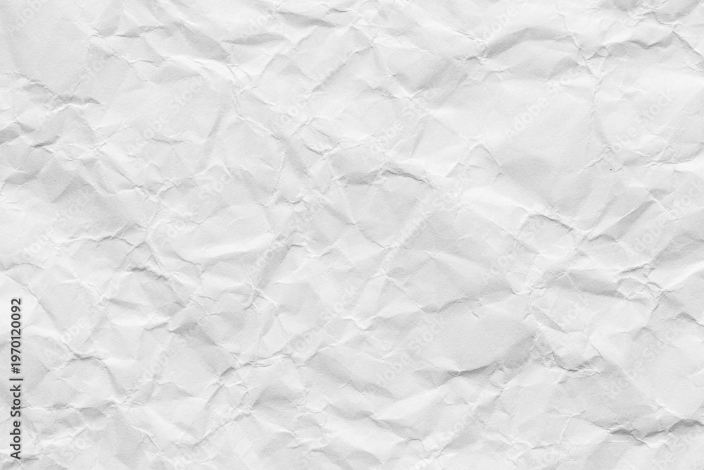 Fototapeta premium Crumpled white paper texture background, Top view of wrinkled paper sheet,macro,Close-up of a white crumpled paper texture background. Highly detailed wrinkled surface of empty paper sheet with shadow
