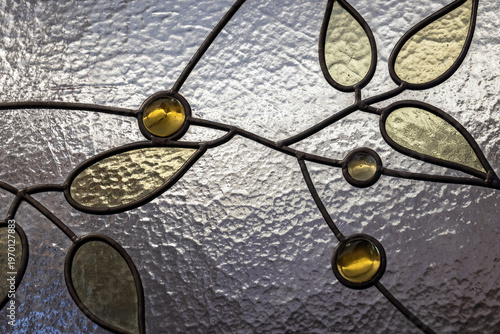 Obraz na plátne Ornamental stained glass panel featuring leaf-shaped panes, textured background