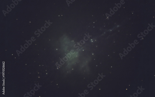 Abstract dark background with scattered bokeh lights and a central green glow