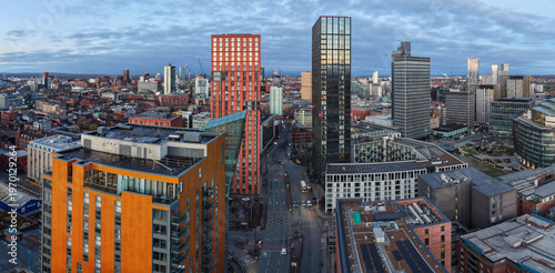 A wide aerial panorama of Manchester’s NOMA district in Manchester at dawn. 