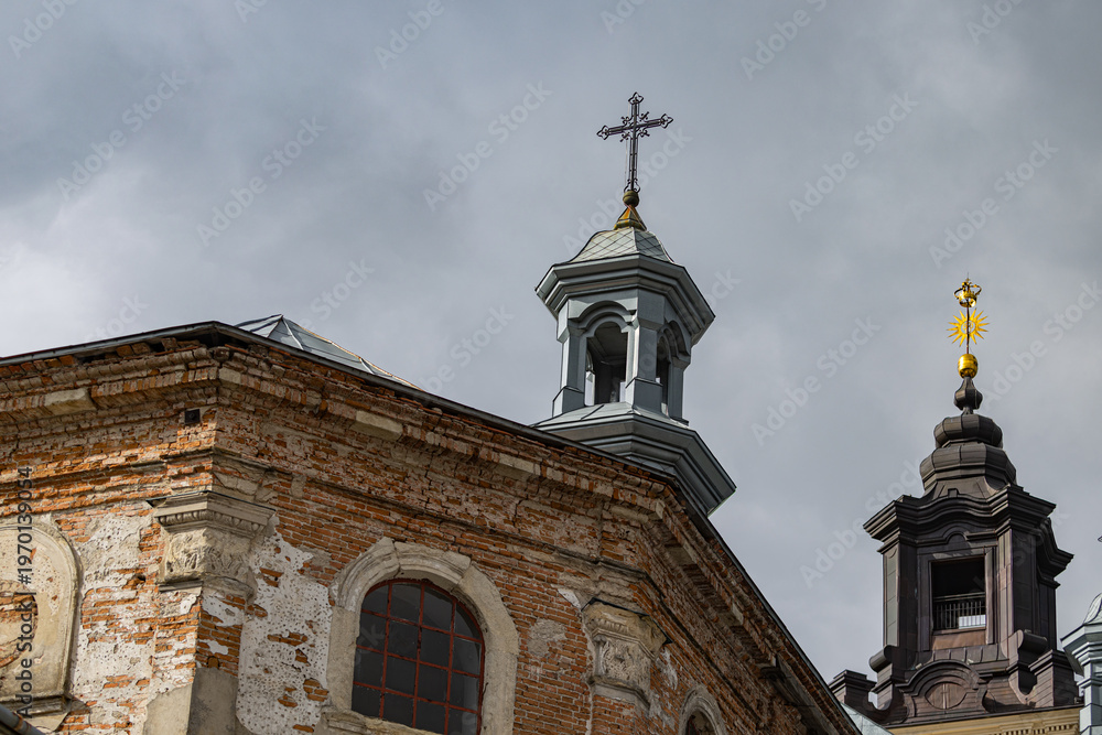 Fototapeta premium Ancient Dominican monastery with bell tower and Virgin Mary column in Pidkamin