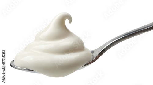 A fresh silver spoonful of sweet white dairy yogurt cream isolated on a healthy dessert plate with milk ingredients