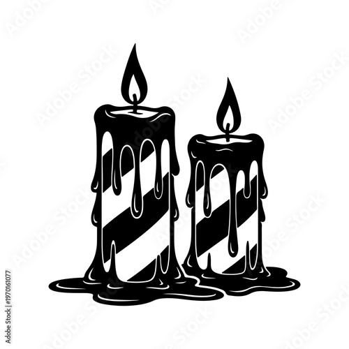 Two black dripping candles with melting wax and flickering flames