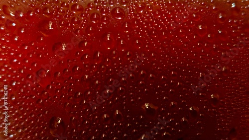 Dehydrated in Detail: A close-up shot of condensation droplets glistening on a deep-red surface, creating a captivating visual texture and emphasizing detail.