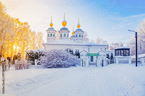 Winter landscape with Resurrection Cathedral in Cherepovets at sunset, Vologda region, Russia. Beautiful Orthodox church with golden domes covered in white snow. 