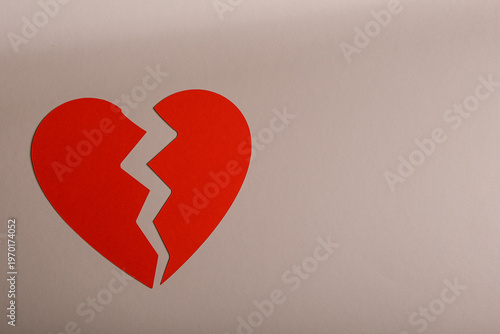 Red paper heart broken in h...
