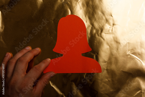Hand holding a red paper si...
