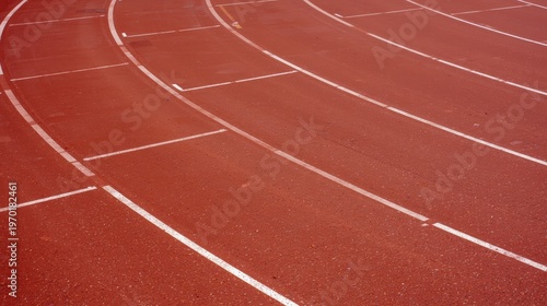 A close up view of an empty red running track with white lane markings curving around the stadium isolated on white background