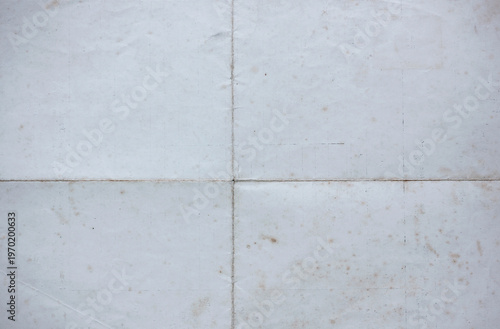 Vintage folded paper texture with visible crease lines and subtle stains, aged surface background ideal for design projects, retro layouts, scrapbook materials and creative graphic applications