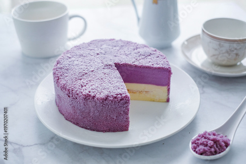 Cuadro en lienzo A vibrant and delicious taro cheesecake, showcasing beautiful purple and white layers, with a slice removed to reveal its creamy texture