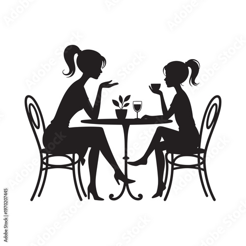 Two women converse over drinks at a small cafe table