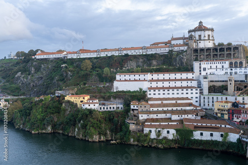 Serra do Pilar Monastery and Dom Luis I Bridge at Dusk under Cloudy Sky