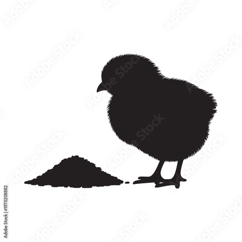 Silhouette of a fluffy chick pecking at a pile of feed