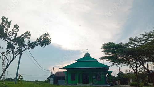 Small Local Mosque with Green Painted Walls and Tiered Roof.