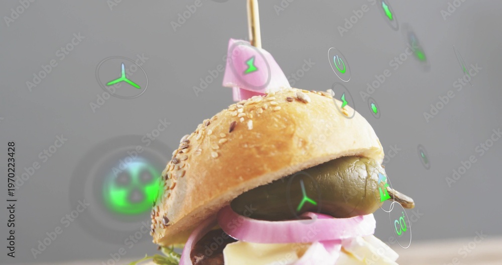 Fototapeta premium Displaying seeded slider topped with wooden skewer and pink flag in studio, with green AR icons