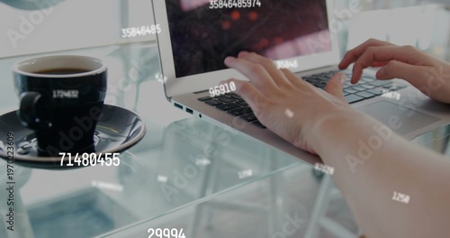 Typing short-sleeved arms on laptop at glass table in cafe, coffee cup and HUD overlays