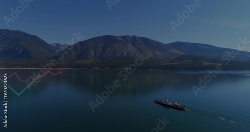 Gliding long ferry leaving V wake across reflecting mountain lake with zigzag, copy space