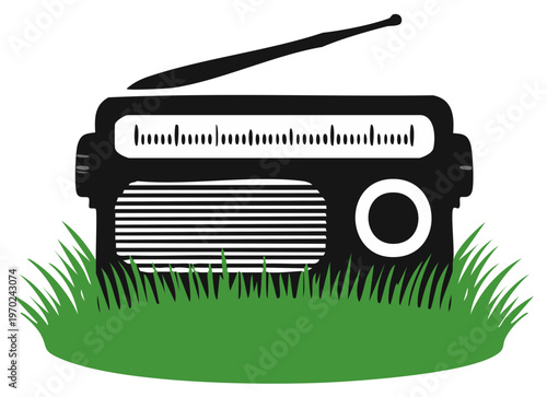 Vintage portable radio with antenna sitting in green grass vector illustration