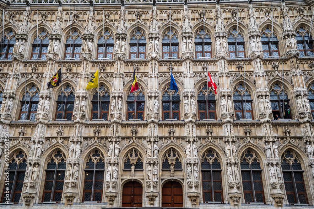 Fototapeta premium Detail of Leuven Gothic Town Hall Facade with Statues and Flags