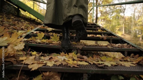 Chic Woman In Leather Boots Stepping Up The Stairs In An Autumn Park