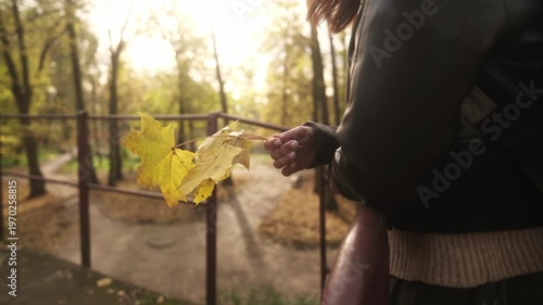 Woman Holding Yellow Maple Leaves In Hands While Enjoying The Golden Autumn Park