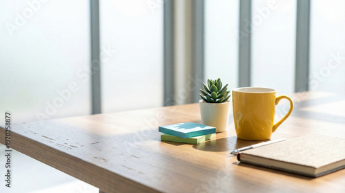 Vászonkép Close-up photograph of a minimalist workspace with a yellow mug, succulent, sticky notes, and notebook on a wooden desk
