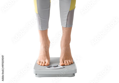 Close-up of person feet standing on a gray analog bathroom scale for weight monitoring and fitness concept.