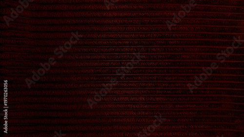 rich dark red corduroy texture closeup captures horizontal ridges in mysterious moody atmosphere