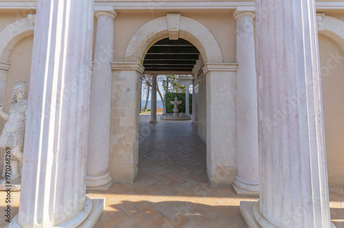 Fotografija Classical architecture view through a stone archway with tall fluted columns and