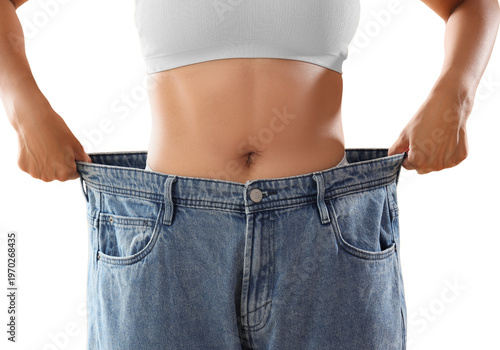 Woman showing weight loss result holding large jeans isolated on white, fitness success and healthy lifestyle concept.