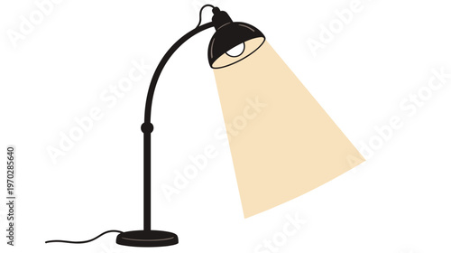 Modern black desk lamp illuminating workspace with warm light  