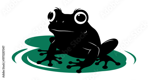 Black Frog Silhouette Sitting on a Lily Pad.