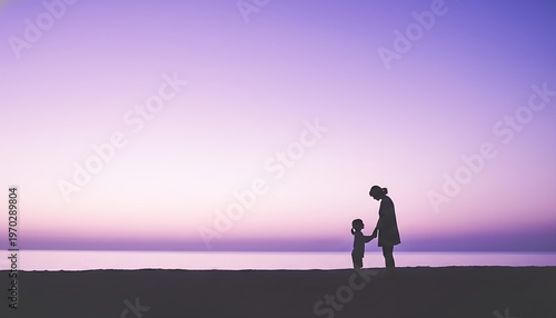 Silhouette of mother and child at sunset on the beach