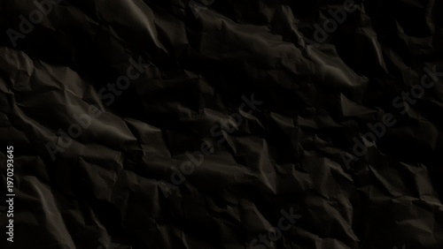Crumpled black paper texture background with wrinkles and folds abstract dark material