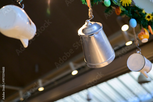 Coffee maker. Metal carafes hanging from a kitchen ceiling