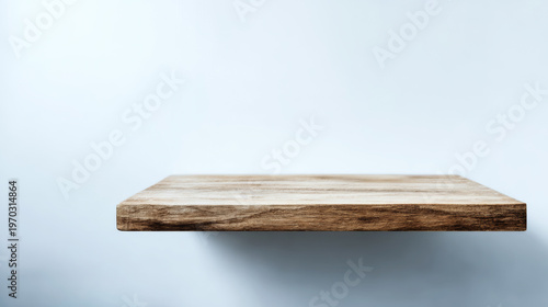 Empty wooden shelf against a blank light background, creating minimal product display space