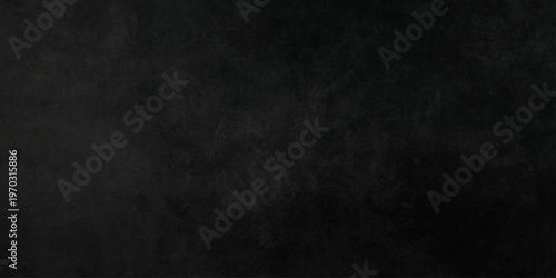 A dark and vintage grunge backdrop featuring a rough black paper texture with an aged grey concrete pattern on a blank weathered surface