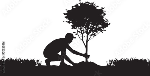 Silhouette of a man tending to a newly planted tree