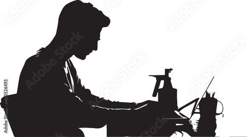 Silhouette of a person working at a desk with a laptop and spray bottle