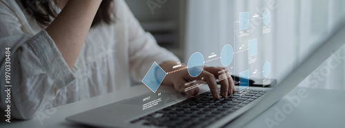 Valokuva Person Using Laptop with Digital Interface Displaying Data Visualization and Graphs in Modern Workspace Environment Quark
