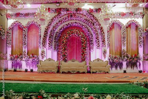 Wallpaper Mural Lavish Floral Wedding Stage Decoration with Elegant Seating and Sparkling Chandeliers for Grand Celebrations and Festive Events Torontodigital.ca